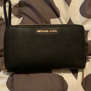 Black and gold Michael Kors wristlet wallet.